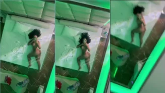 La caliente Amanda Luz yace desnuda en la cama, mirándose en el espejo